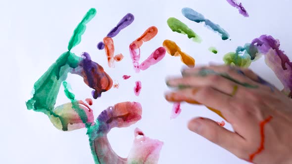 Creative Concept  Man and Woman Make Prints of Their Painted Hands on a White Background alt