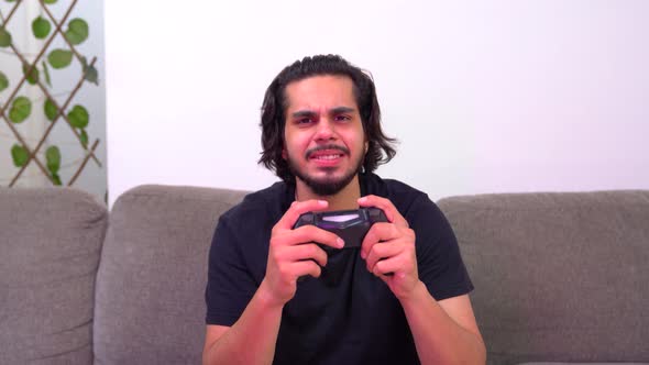 Competitive Indian gamer playing video game late at night and losses a match alt