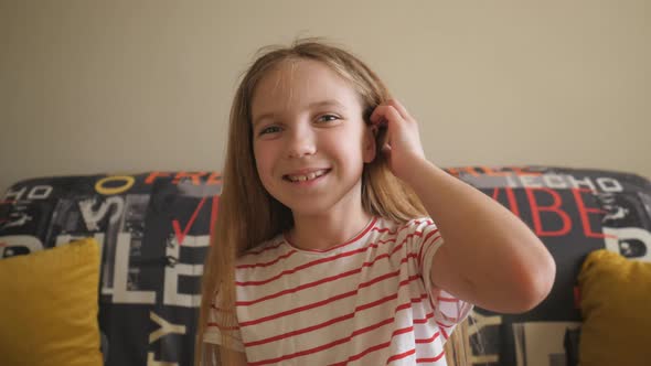 Portrait of Happy Blonde Girl Looking Into Camera and Laughing Indoor alt