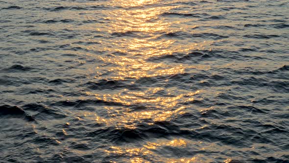 Background of Calm Sea. Sea with Little Waves Close Up. Deep Blue Ocean with Sun Reflecting in the