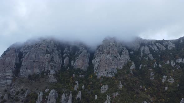 Aerial Footage Above a Foggy Mountain During Fall Season alt