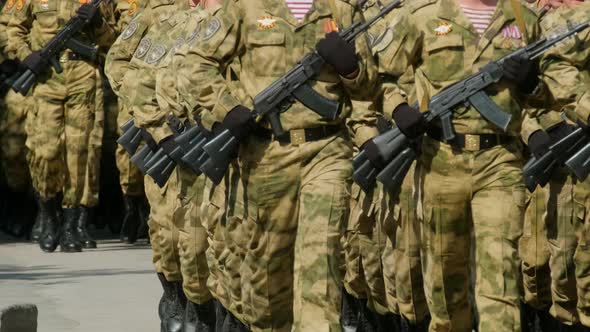 March Military Officers with Assault Rifle Kalashnikov Ak 47 in Arm Closeup . alt