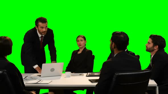 Businessman touching invisible screen while using laptop alt