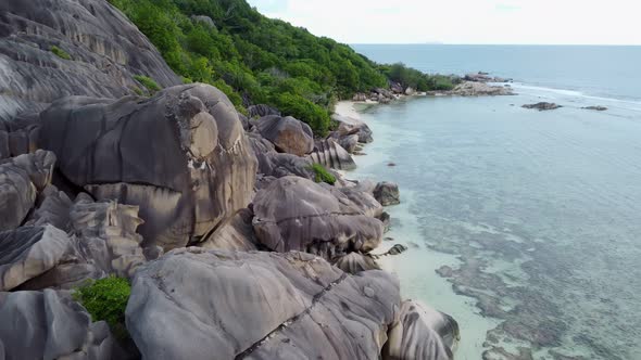 a beach with big rocks in the Seychelles