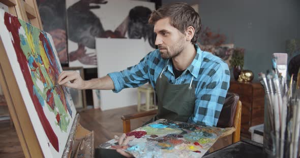 Male Artist Working in Studio