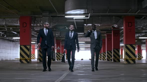 Businessmen Walking in Underground Parking Lot, Stock Footage | VideoHive