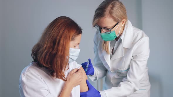 Doctor Vaccinating Female Patient