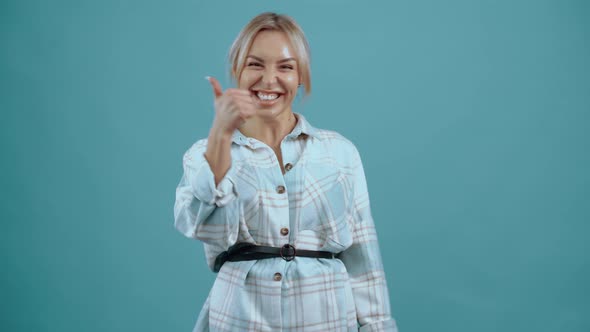 The Enthusiastic Young Woman Shows Her Thumb Up As a Sign She Confirms
