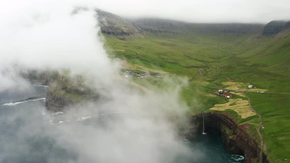 Sunset View of Mulafossur Waterfall and Gasadalur Village alt