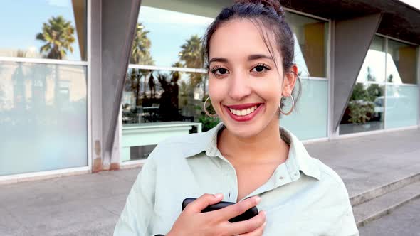 Young Entrepreneursmiling to camera while holding her tablet confident, young women in business