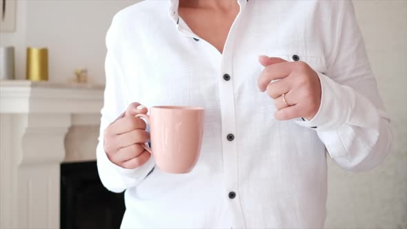 person holding a cup of coffee and dancing