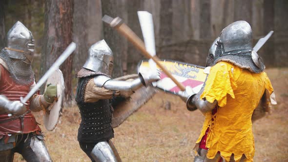 Four Men Knightes Having a Training Fight on the Field in the Middle of the Forest alt