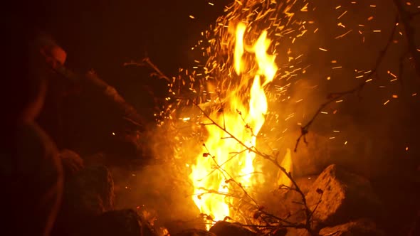 A Close Up of Burning Bonfire with Sparks at Night After Hiking in the Mountains