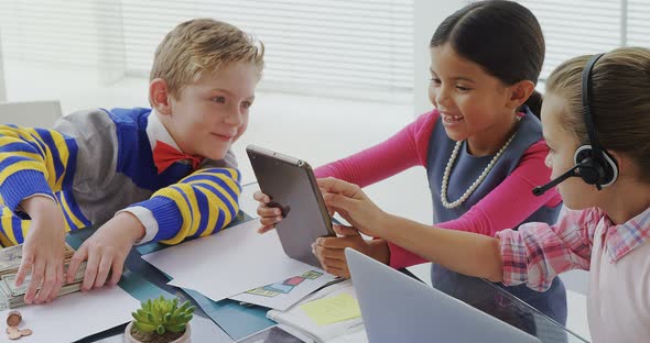 Kids as executive discussing over a digital tablet 4K alt