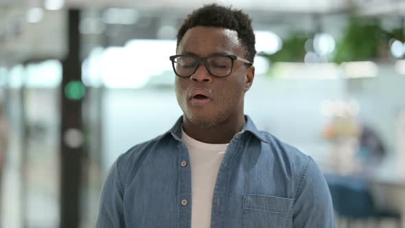 Portrait of Sick African Man Sneezing alt