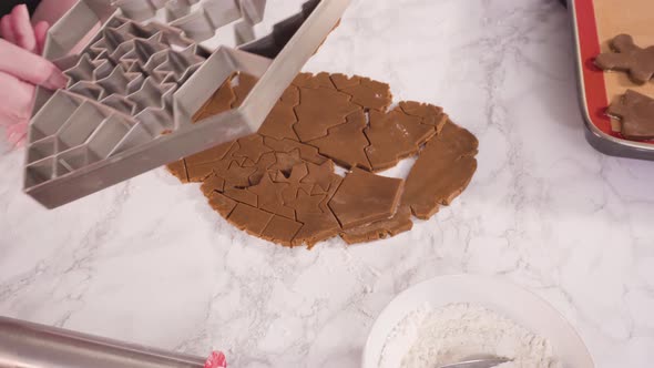 Step by step. Cutting out shapes with Christmas cookies cutter from gingerbread cookie dough alt
