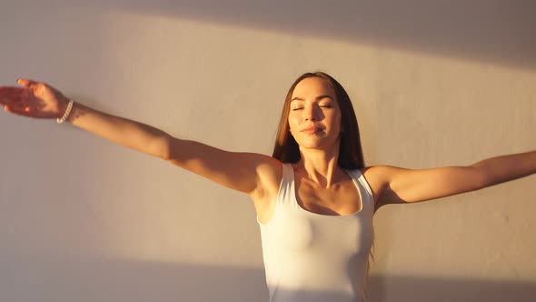 Woman Practicing Yoga in a Studio Indoors.