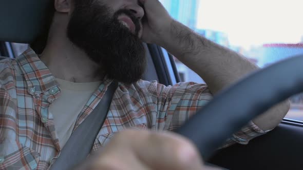 Tired Middle-Aged Male Driver Having Headache in Traffic, Rubbing Temples