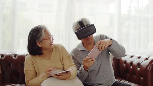 Senior couple having fun to playing game in VR glasses