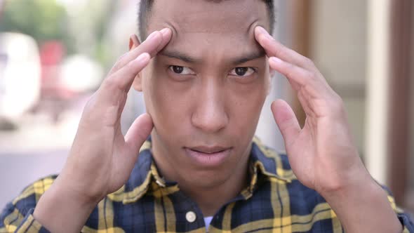 Close Up of Frustrated Young African Man with Headache alt