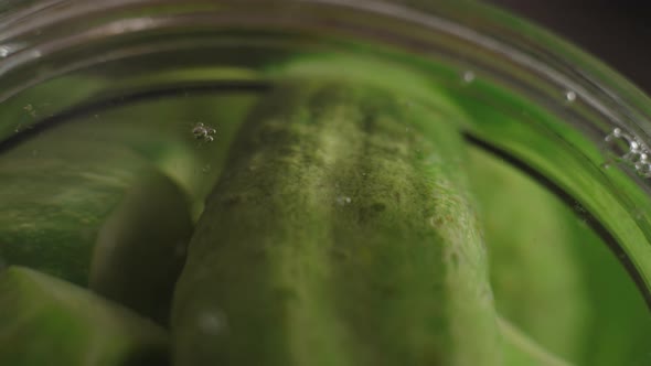 Macro Air Bubbles Rise From Cucumber Jars for Marinade Making Filled with Boiling Water alt