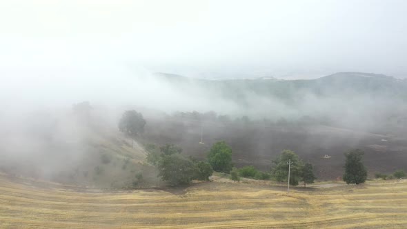 Fog in the countryside over fields and lands in autumn alt