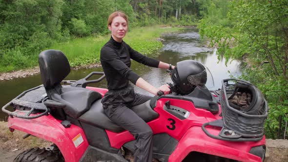 Woman Posing on Quad Bike in Forest alt