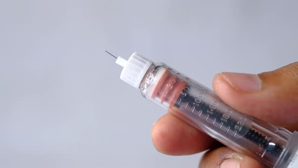 Hand Holding Insulin Pens with Copy Space, Top Down alt