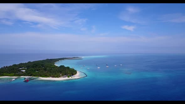 Aerial scenery of beautiful shore beach time by blue ocean and white sand background of a daytrip ne alt
