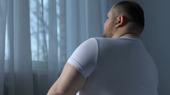 Lazy Obese Man Exercising Shoulder Muscles, Rheumatology Disorder, Lack of Sport alt