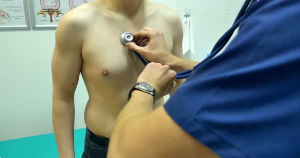 Clinic Physician Examining Man By Stethoscope alt
