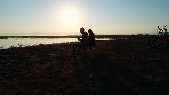 Reading a Book at Sunset alt