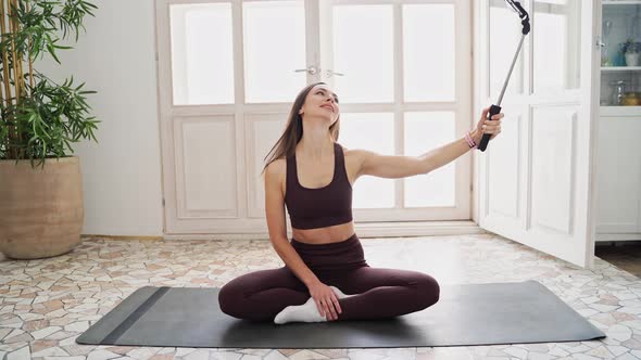 Young Woman Doing Self Portrait on Yoga Mat