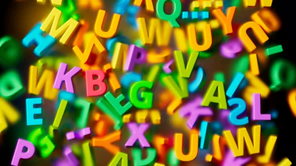 Many colorful letters falling down into a pile on transparent glass. 4K HD alt