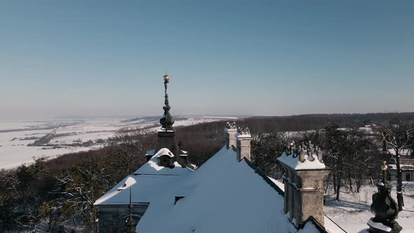 Aerial View Drone Flight Forward Over the Roof of Historic Old Castle at Sunny Winter Day Pidhirtsi