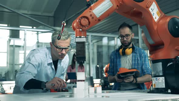 Experiment with Robotlike Devices is Being Held By Young Scientists alt