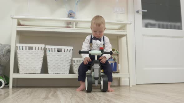 Kid on Baby Bicycle Balance Bike for Toddlers with Colorful Balloons 1 Year Old Baby Boy Celebrating alt