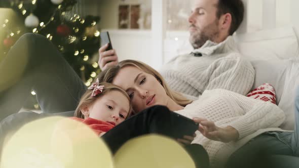 Video of family using technology at boring Christmas day. Shot with RED helium camera in 8K. alt