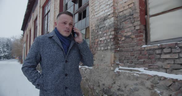 A Man Walks the Old Streets and Talks on a Cell Phone alt