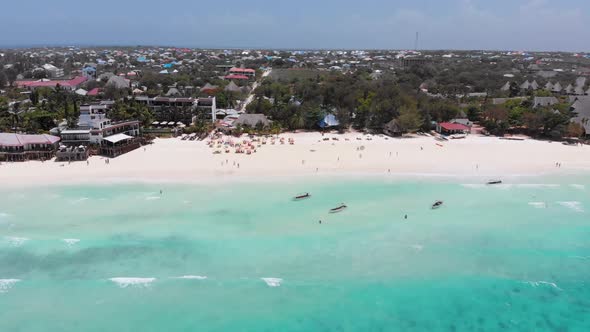 Exotic Sandy Beach with Turquoise Ocean Boats and Hotels Zanzibar Aerial View alt