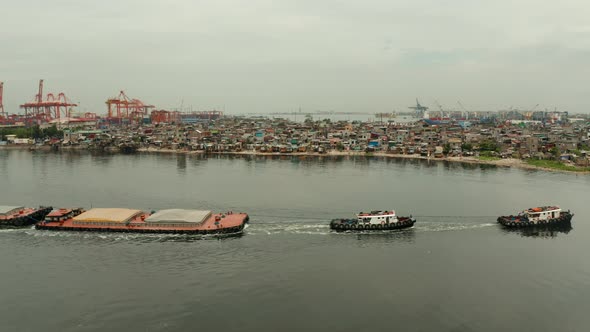 Tugboat Pulling Heavy Loaded Barge alt
