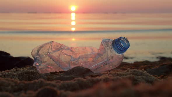 Cleaning Plastic Garbage on the Beach Man Collects Mud and Throws It Into Bag alt
