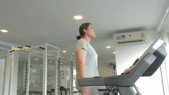 Asian Woman FitnessAsian Woman working out on Various Fitness EquipmentFitness Equipment alt