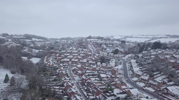 High descending drone shot of snowy Exeter subburbs alt