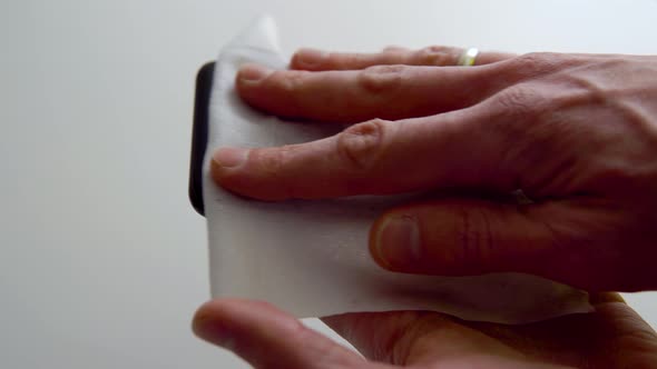 Cleaning the Smartphone Screen with a Fiber Cloth From Dirt Dust and Other External Factors alt