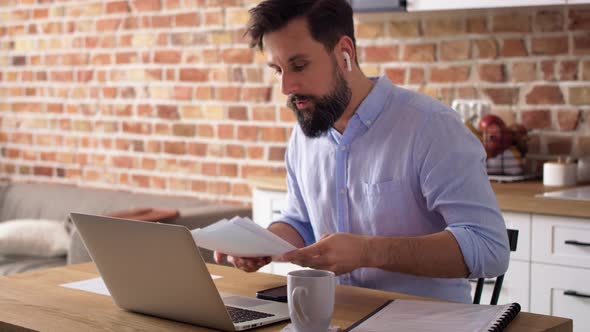Handheld video of man during video conference at home. Shot with RED helium camera in 8K. alt