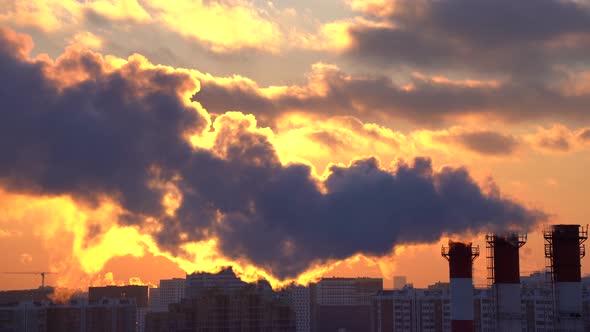 smoke from chimneys on a frosty winter evening in the contoured light of the sun alt