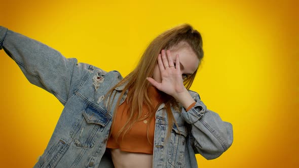 Trendy Cheerful Girl Dancing and Moving to Rhythm Dabbing Raising Hands Making Dubdance Gesture alt
