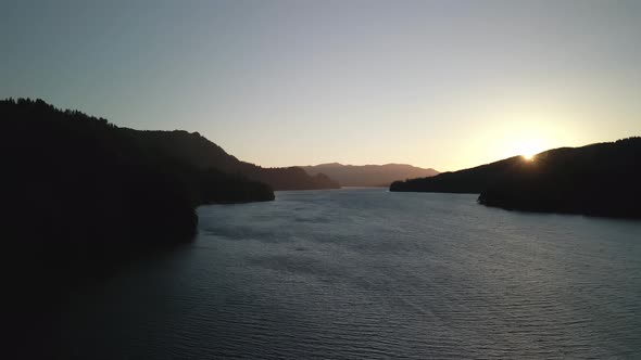 Bird'seye View of the Sunrise Over the River with Hilly Terrain alt