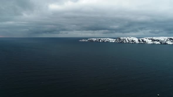 Aerial Shot of the Arctic Ocean in a Bad Pagoda with Gray Clouds That Carry a Storm Off a Rocky